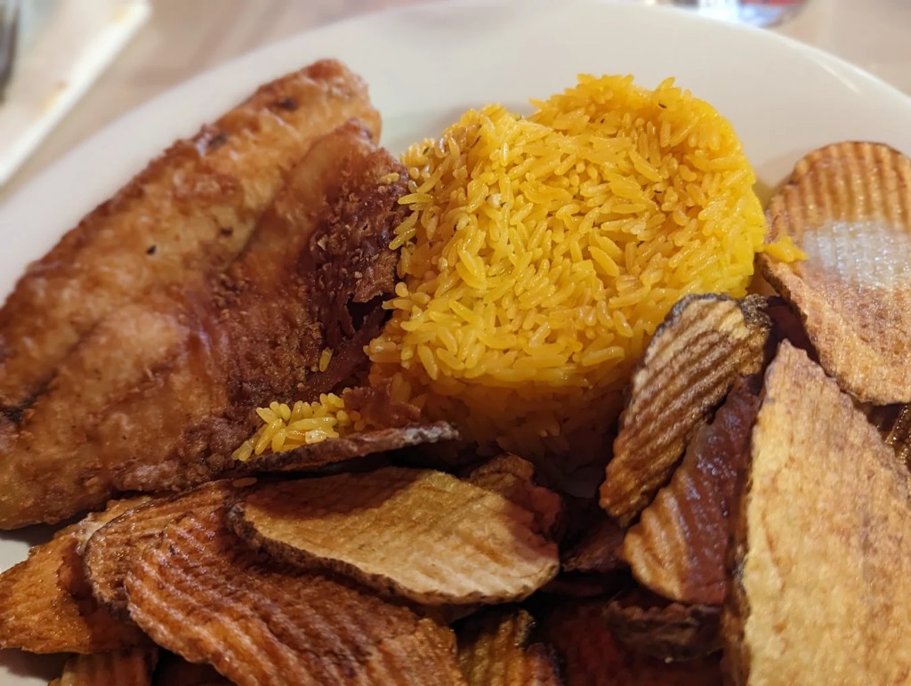 Fried fish platter with yellow rice and house chips