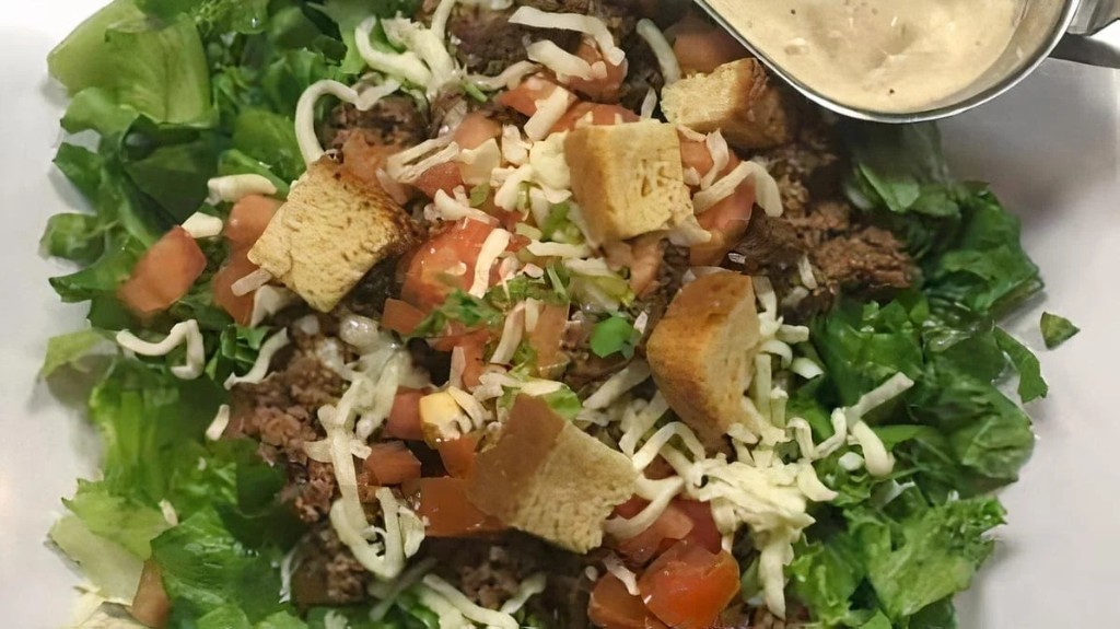 Fresh salad with meat, cheese, and croutons